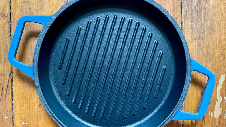 A cast-iron grill pan with two wide handles on either side.
