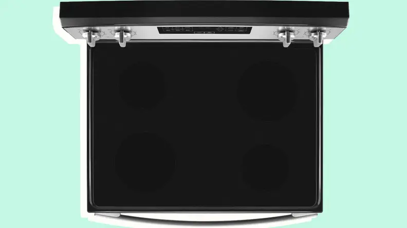 Close up of a black rangetop on a stainless steel kitchen appliance.
