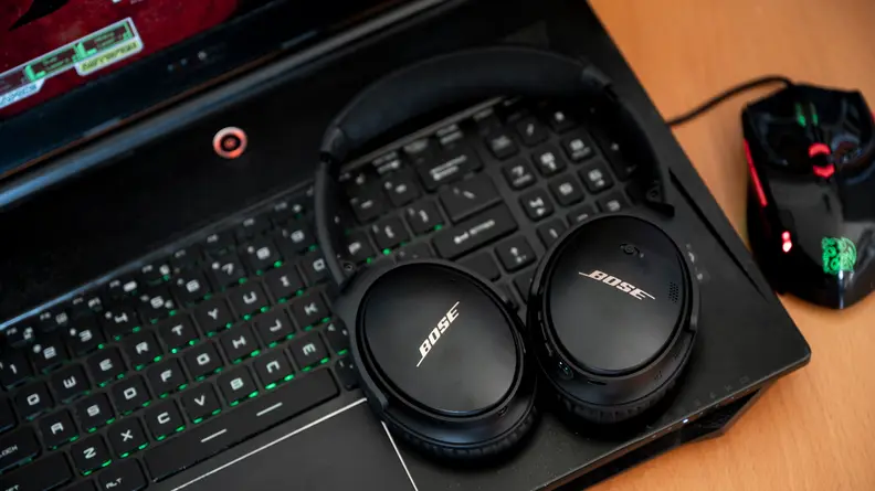 Headphones sitting on top of a laptop