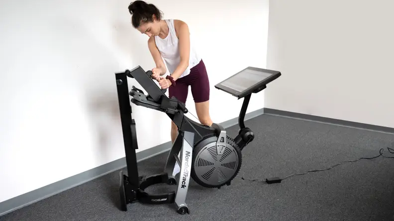 Woman folding NordicTrack RW900.