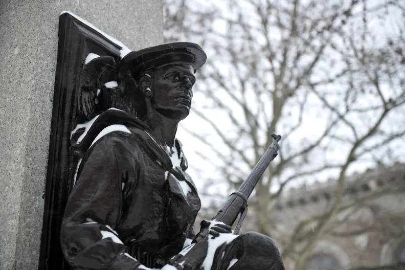 A photo of a statue of a soldier taken during winter storm Juno.