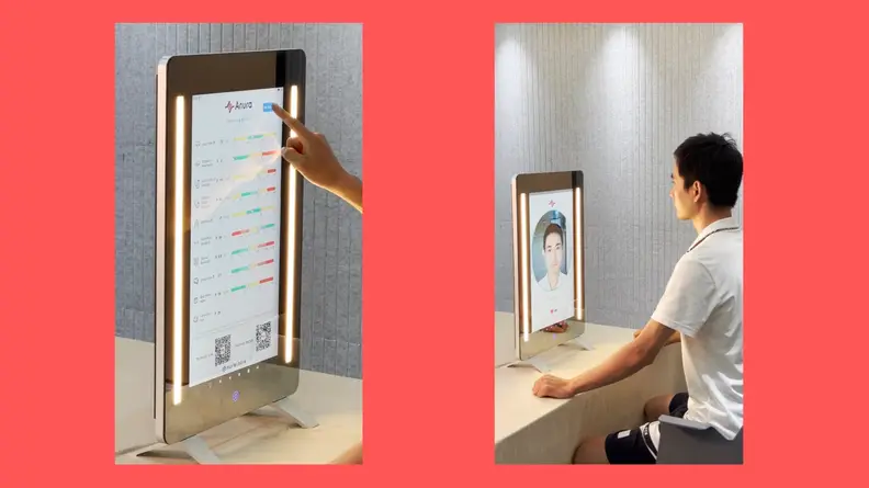 A close up of the health monitoring Anura magic mirror and a user having a facial video clip recorded for analysis.