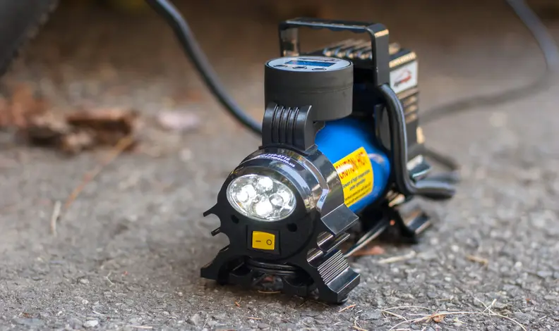 EP Auto Compressor with light, sitting on pavement