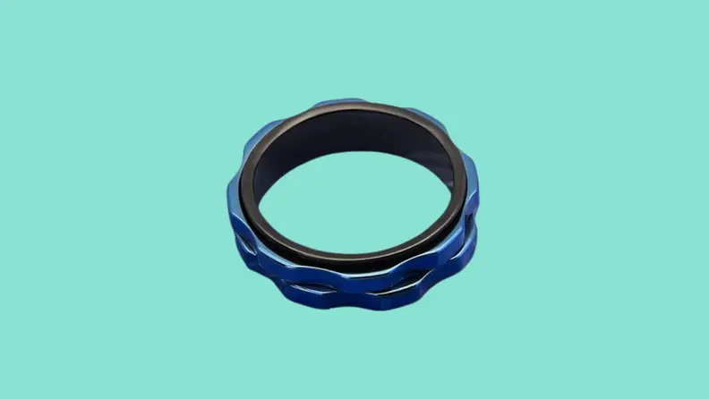 A Lucky Armor Fidget Ring on a teal background.