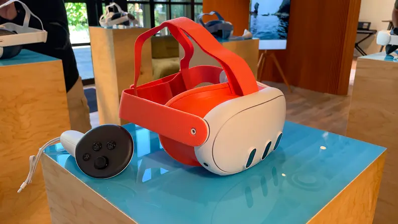 A white VR headset with orange strap
