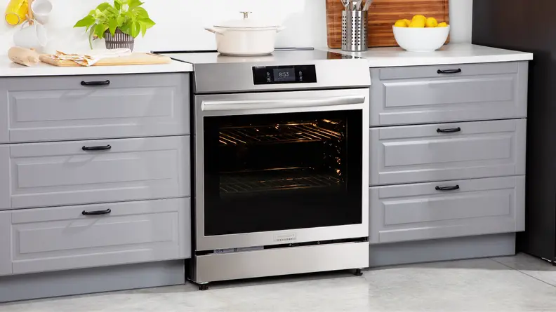 Frigidaire Gallery GCFI3060BF 30-inch Induction Range in between two drawers in modern kitchen setting.