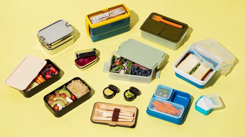 An assortment of snacks and a lunchtime meal sorted in multicolored Bento Boxes.