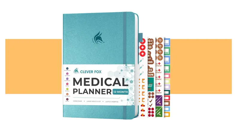 A teal Clever Fox Medical Planner with medical stickers sticking out of it.