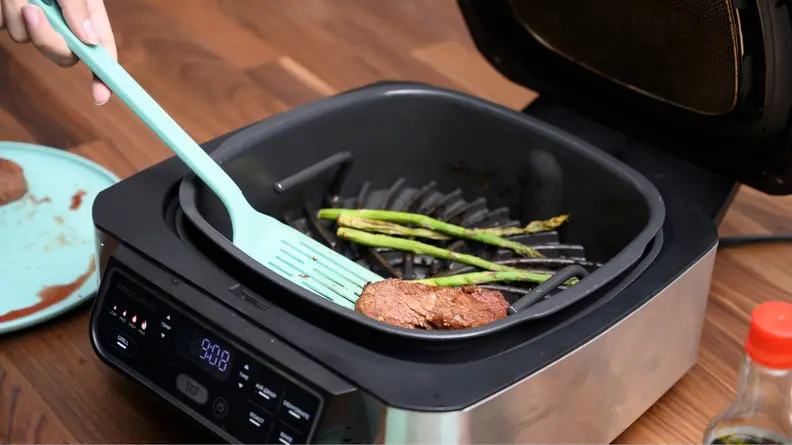 This Ninja Foodi smokeless indoor grill can roast, grill, bake, air fry, and dehydrate.