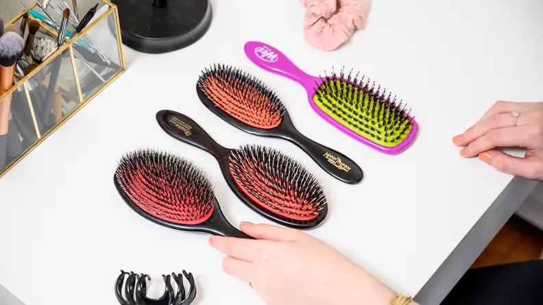 A photo of the Wet Brush, Creative Professional, and Denman alongside the famous Mason Pearson.