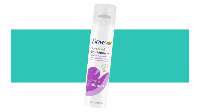 A bottle of Dove Volume & Fullness Dry Shampoo in front of a background.