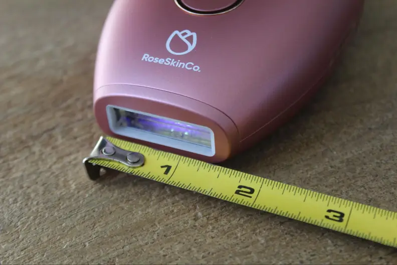 The Lumi permanent hair removal device next to a tape measure.