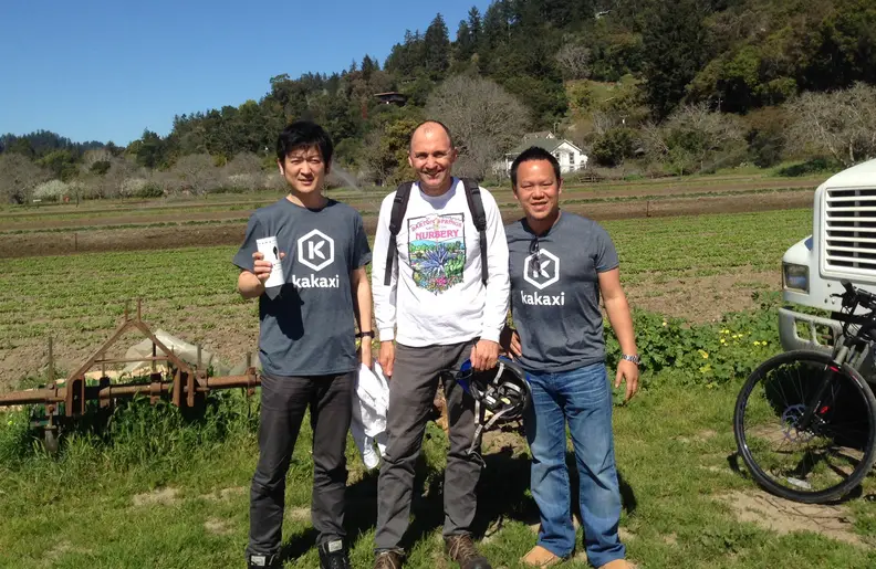 CFO Akihiko Nagata (left) and CEO Taizo Otsuka with the Kakaxi sensor and a local farmer.
