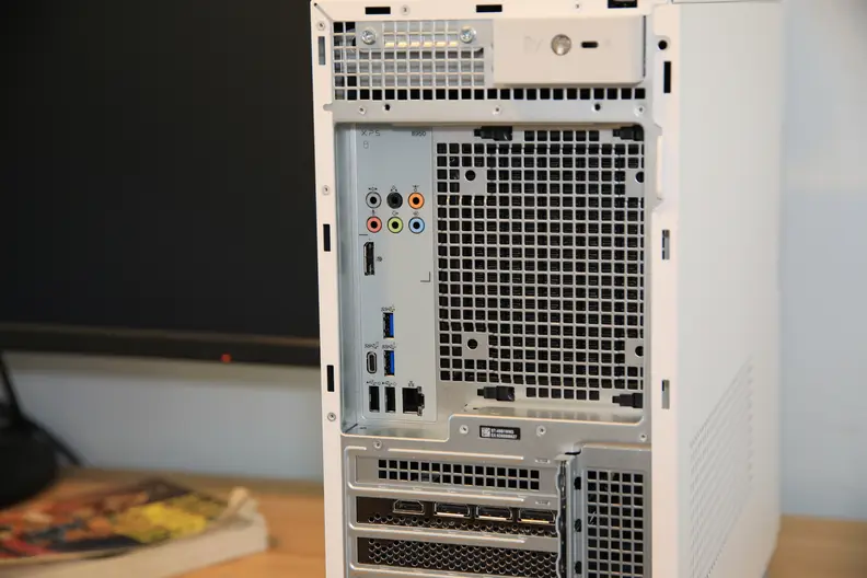 The backside of a Dell desktop computer tower showing ports and plug-ins.