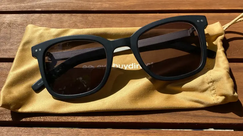Eyebuydirect sunglasses on a yellow cloth