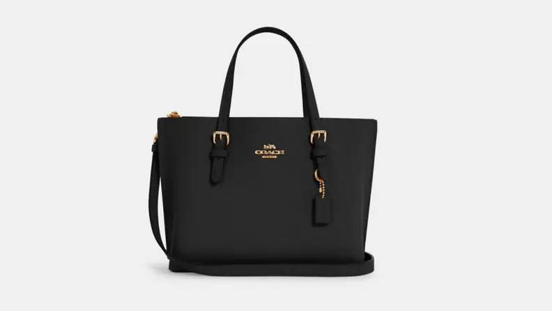 A black Coach bag against a white background.
