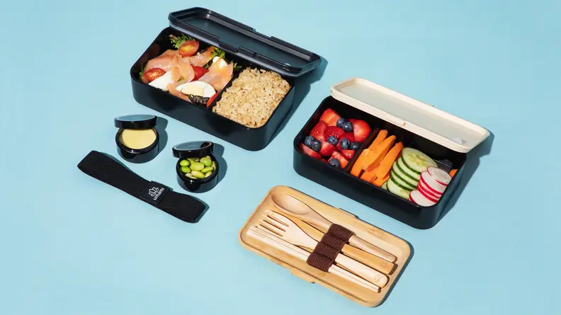 Fresh food like fruits and vegetables are stored in Bento boxes along with utensils.