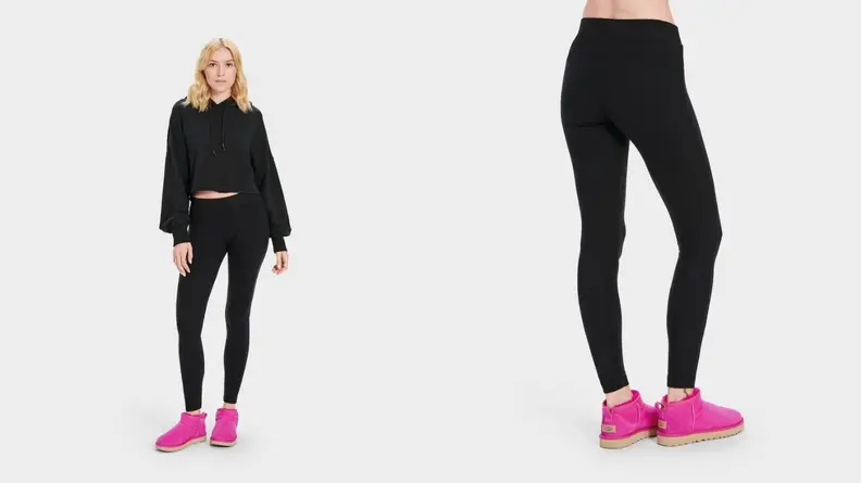 A blond model in black activewear shows off a pair of bright-pink sneakers.