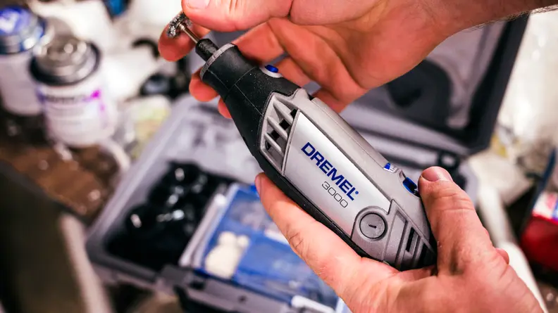 Person holding a dremel 3000 rotary tool