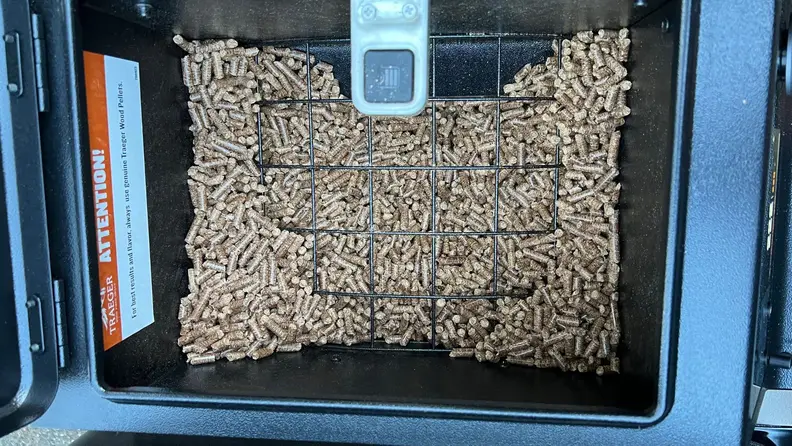 The pellets for the Traeger Ironwood Pellet Grill sitting inside the grill.