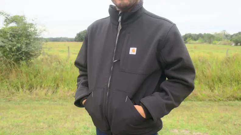 Man putting hands inside of Carhartt Detroit Jac.