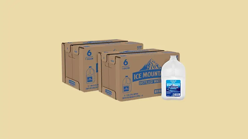 Carton and boxes of water against tan background