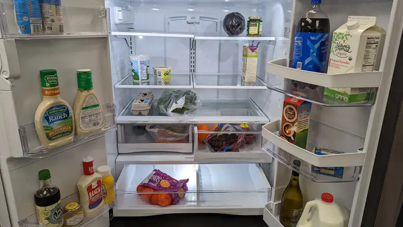 A close-up of the interior of the fridge, fully stocked with food.