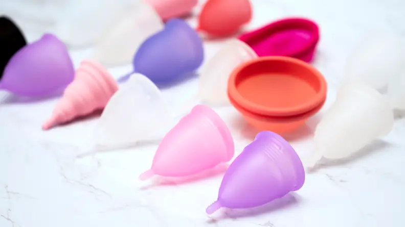 menstrual cups on white marble background