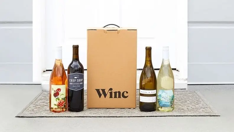 A wine delivery box outside of a front door.