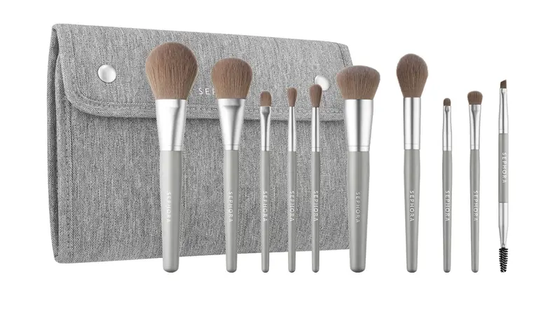 A 10-piece set of makeup brushes in front of a carrying case.