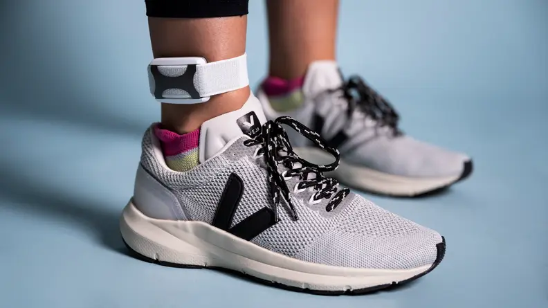A person wears the Apollo Neuro on their ankle.
