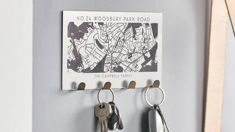 This family-sized key holder has a laser-engraved map of their new neighborhood.
