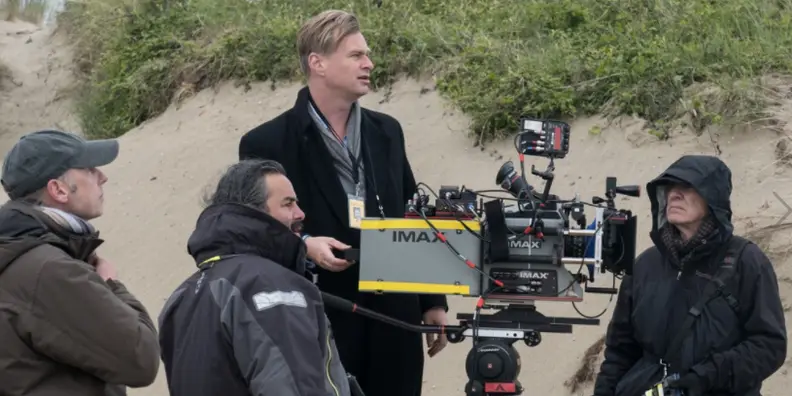 Christopher Nolan on the set of Dunkirk with an IMAX camera