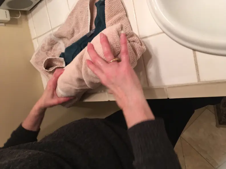 Roll the sweater in a clean, dry towel