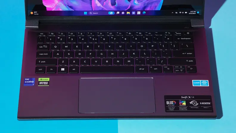 The Acer Swift X 14 on a blue table.