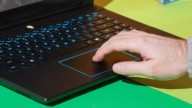Person using fingers on the trackpad of the Alienware m16 R2 gaming laptop.
