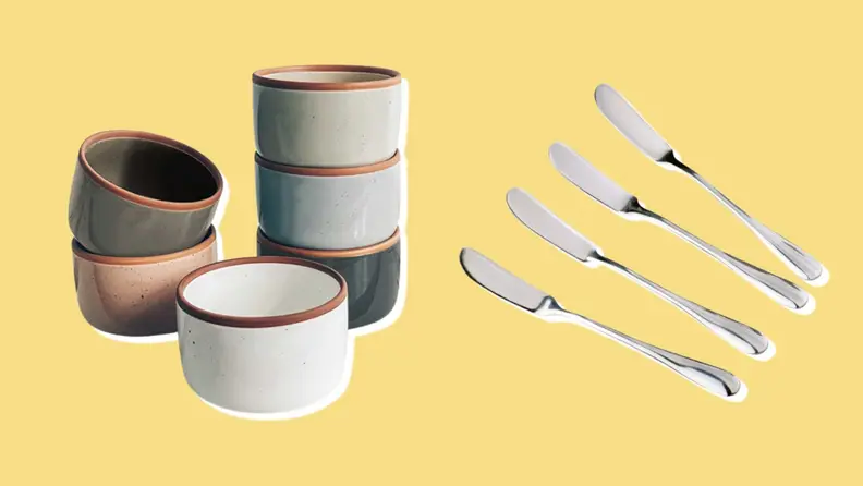 Stacked ramekins and cheese spreading knives on yellow background