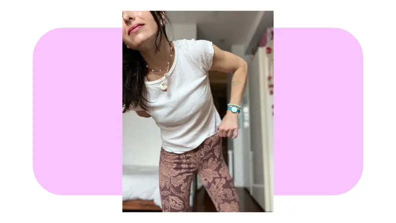 Person modeling the printed Free People Penny Pull-On Flare Jeans.