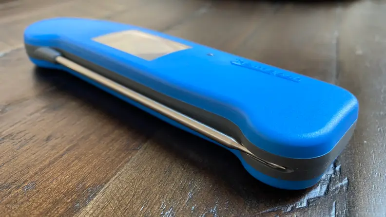 A Thermapen digital meat thermometer in blue is in the center of the image.