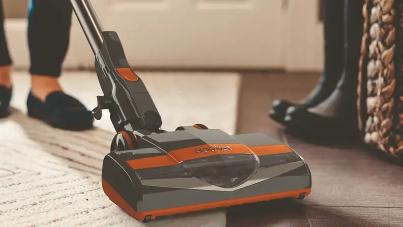 A gray-and-orange Shark Rocket stick vacuum.