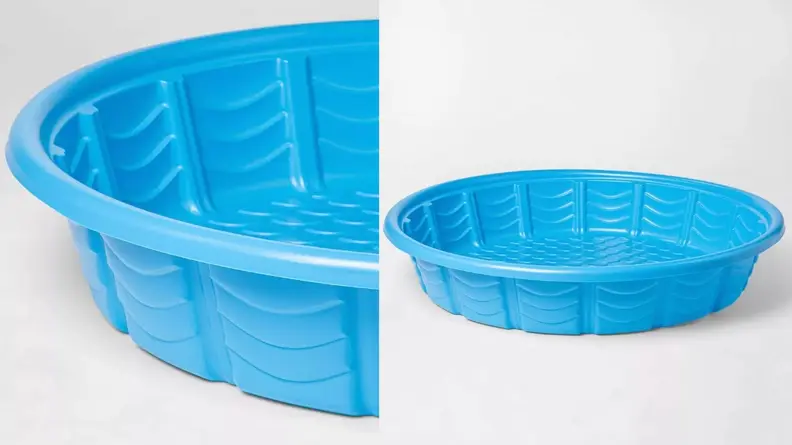 A blue plastic kiddie pool with ridges is photographed on a white background
