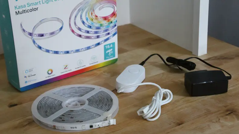 The Kasa Light Strip sitting on a table next to the packaging