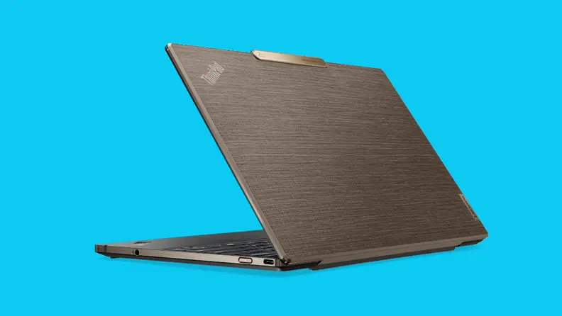 A Lenovo business laptop partially unfolded on a blue background.