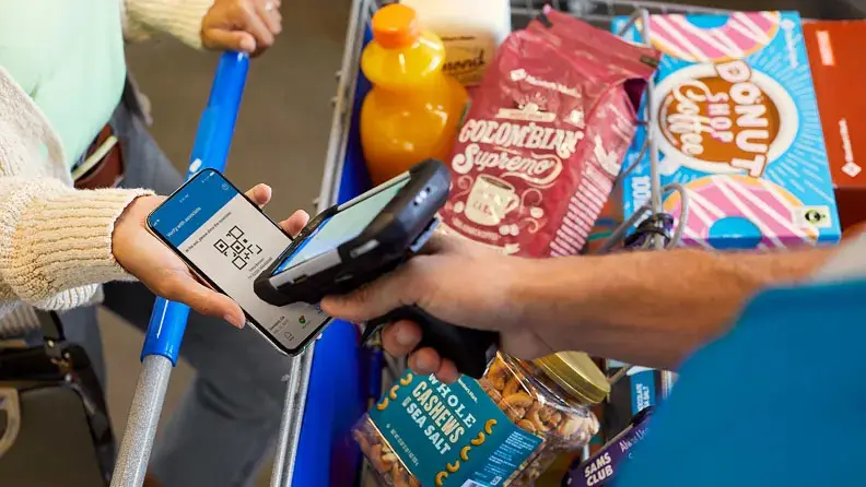 Customer using Sam's Club's Scan & Go feature at checkout