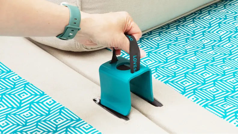 A u-shaped metal clamp fits over the sides of two base sections to connect the Sactional.