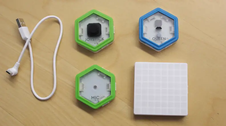 The Juku Light Games Coding Kit includes the Queen module, the Microphone module, the Joystick module, and an LED light grid.