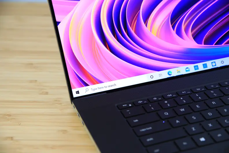A close up of a laptop display showing off colorful wallpaper.