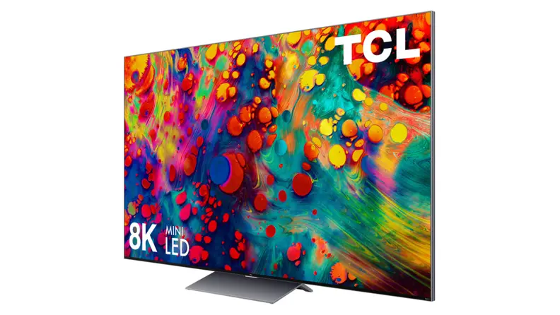 A massive 8K TCL television is shown at an angle, colorful swirls of paint on the display.