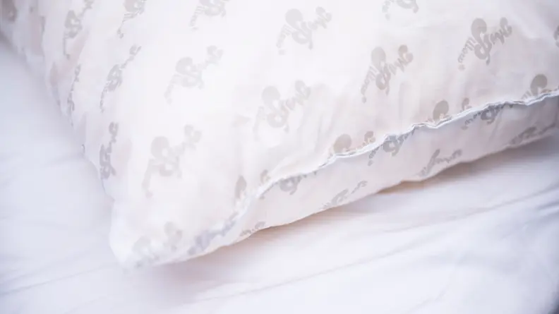 Corner of a pillow with the MyPillow logo printed all over.