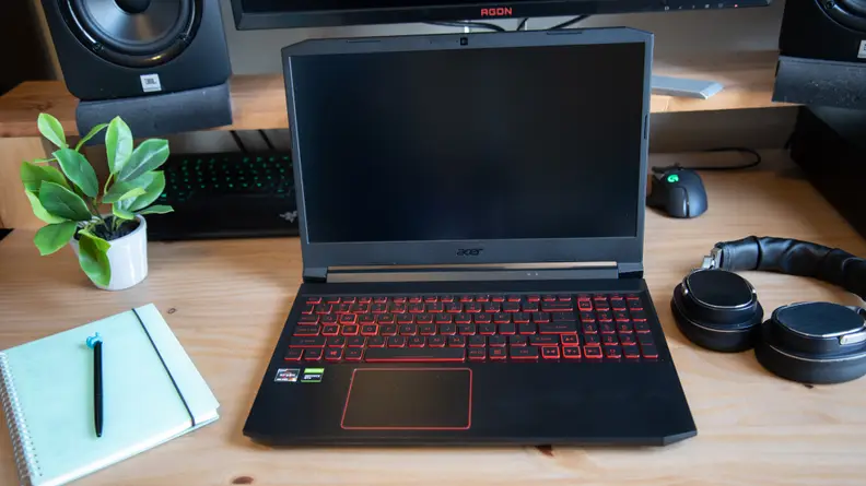 An overshot of the laptop with a journal to the side